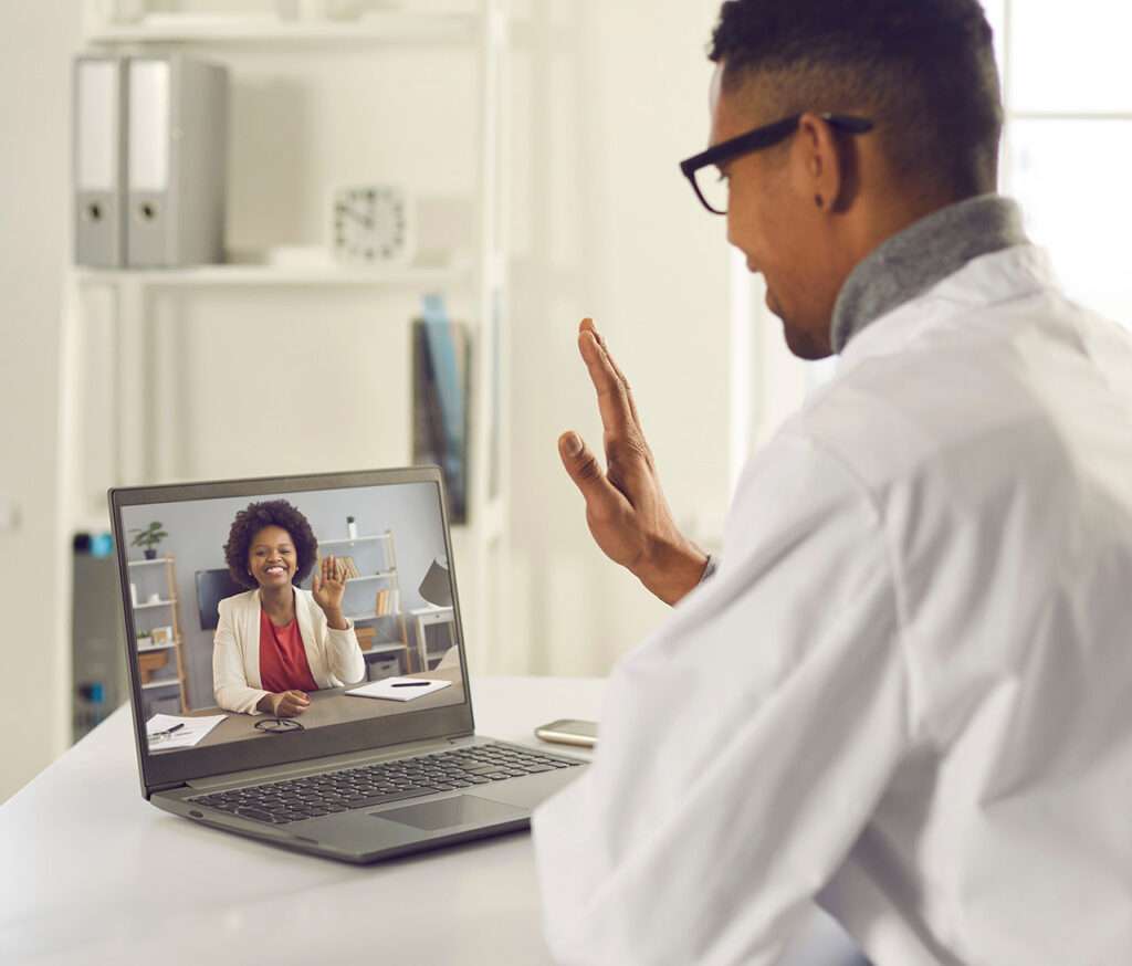 African american male doctor having a virtual consultation with female patient.