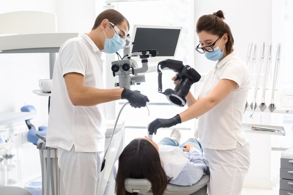 A patient receiving dental treatment from a dentist in an office setting.