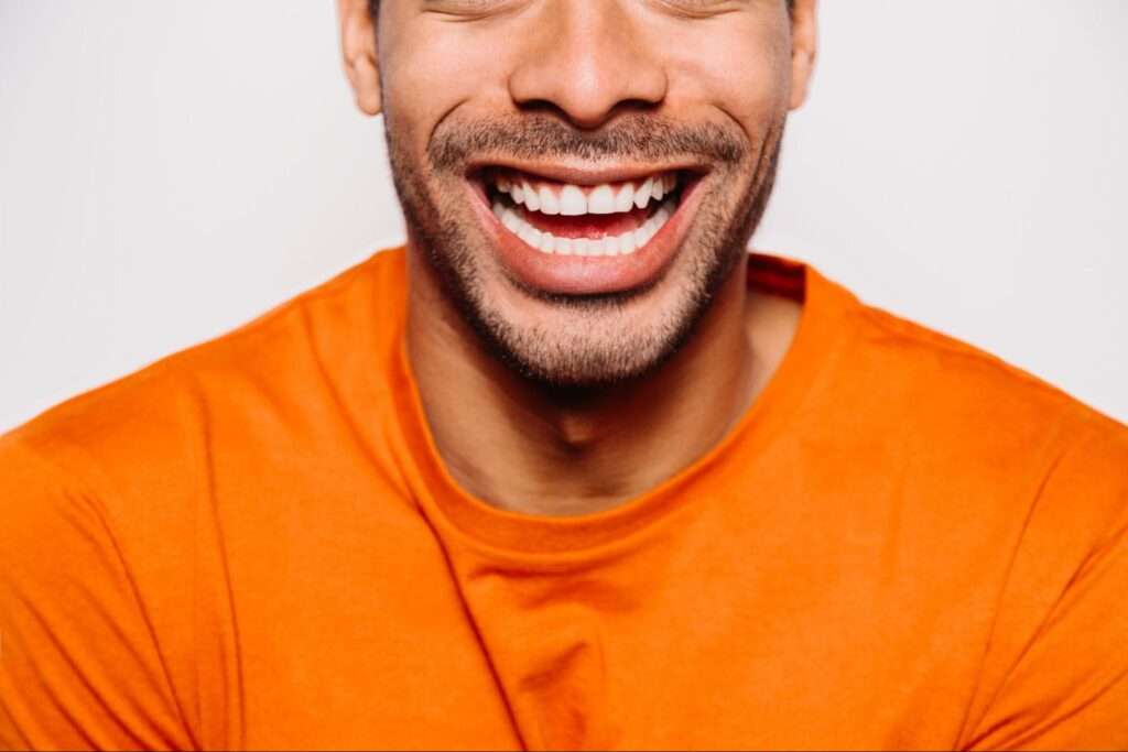 Man smiling with straight teeth. 